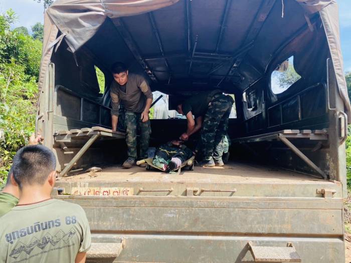 Kameraden verladen einen verletzten Soldaten nach der Minenexplosion auf ein Armeefahrzeug zur Evakuierung. Foto: Royal Thai Army