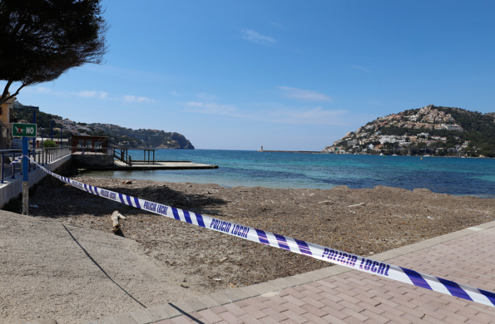 Mit einem Absperrband der Polizei ist der Zugang zu einer Badestelle auf der Insel Mallorca wegen der Corona-Pandemie abgesperrt. Foto: Clara Margais/dpa